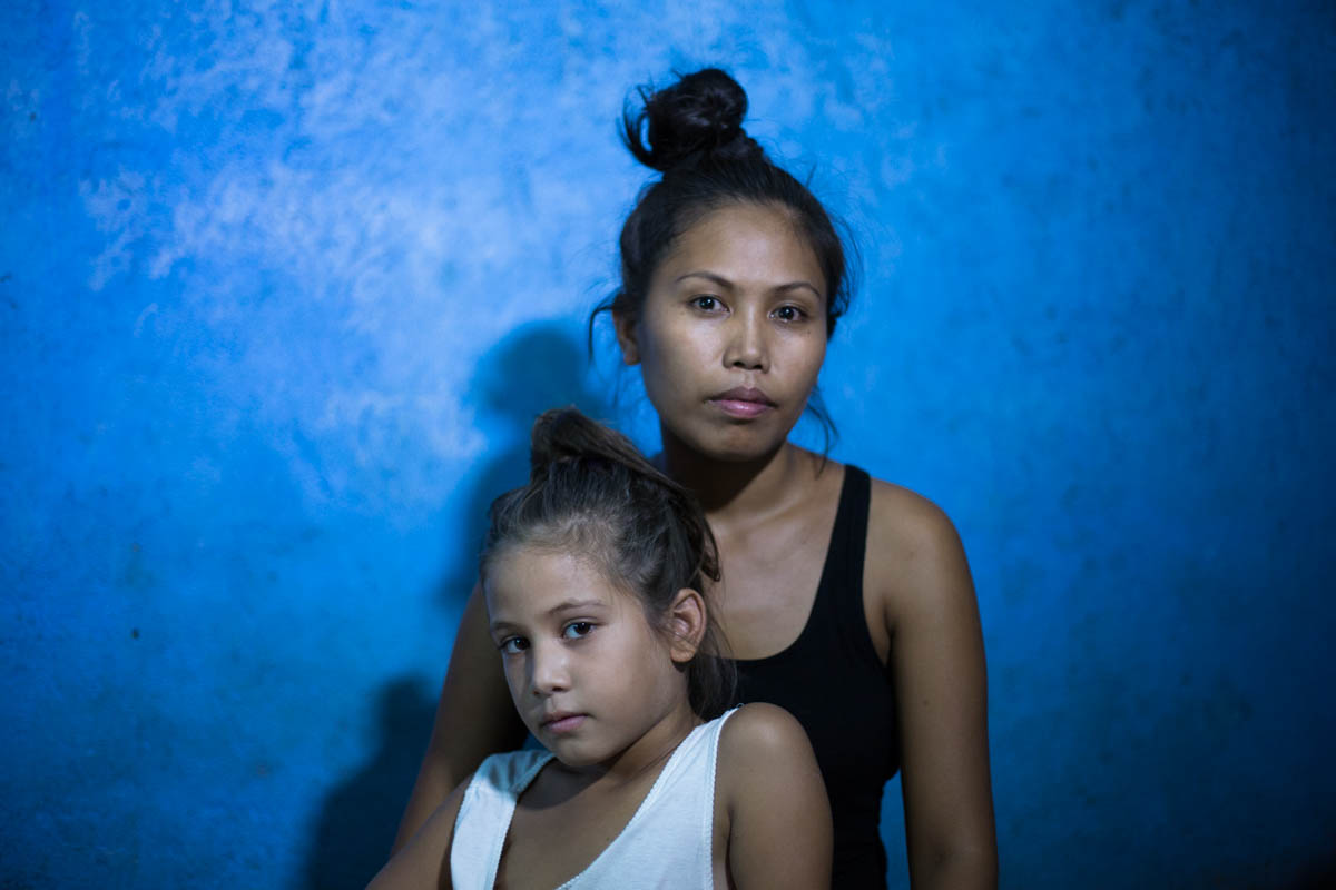 Nathalie and Blessimai - Nathalie, 32, and Blessimai, 9, in their house in Mabalacat. Nathalie works in Fields Avenue to give a better future to her seven children.  Mabalacat near Angeles City, Philippines, May 2015. - Copyright © © S. Borcard - N. Metraux - Mabalacat City - Central Luzon - Philippines - <A href="https://maps.google.com/?ll=15.229155,120.604955&z=16" target="_blank">(Map Nathalie and Blessimai)</A>