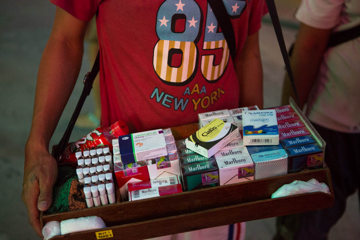 Viagra on display - Street vendor on Fields Avenue. Besides selling cigarettes and lighters, he also sells Viagra and Cialis for 500 pesos (10 €) a box.  Angeles City, Philippines, May 2015. - Copyright © © S. Borcard - N. Metraux - Angeles - Central Luzon - Philippines - <A href="https://maps.google.com/?ll=15.167375,120.588597&z=16" target="_blank">(Map Viagra on display)</A>