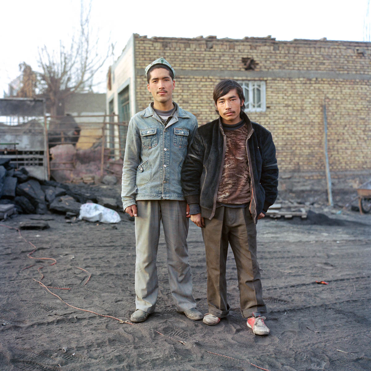 Young Uyghur men - Young Uyghur men at a coal depot. Hotan, Xinjiang, China 2012.