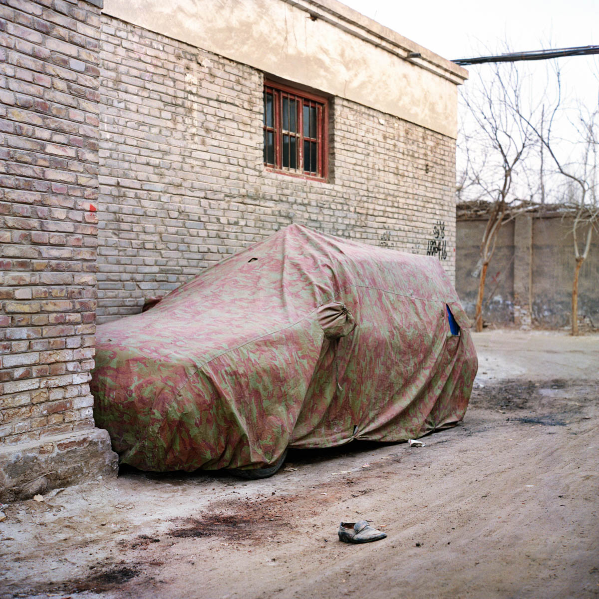 Camouflage - Car under a camouflage tarpaulin. Hotan, Xinjiang, China 2012.