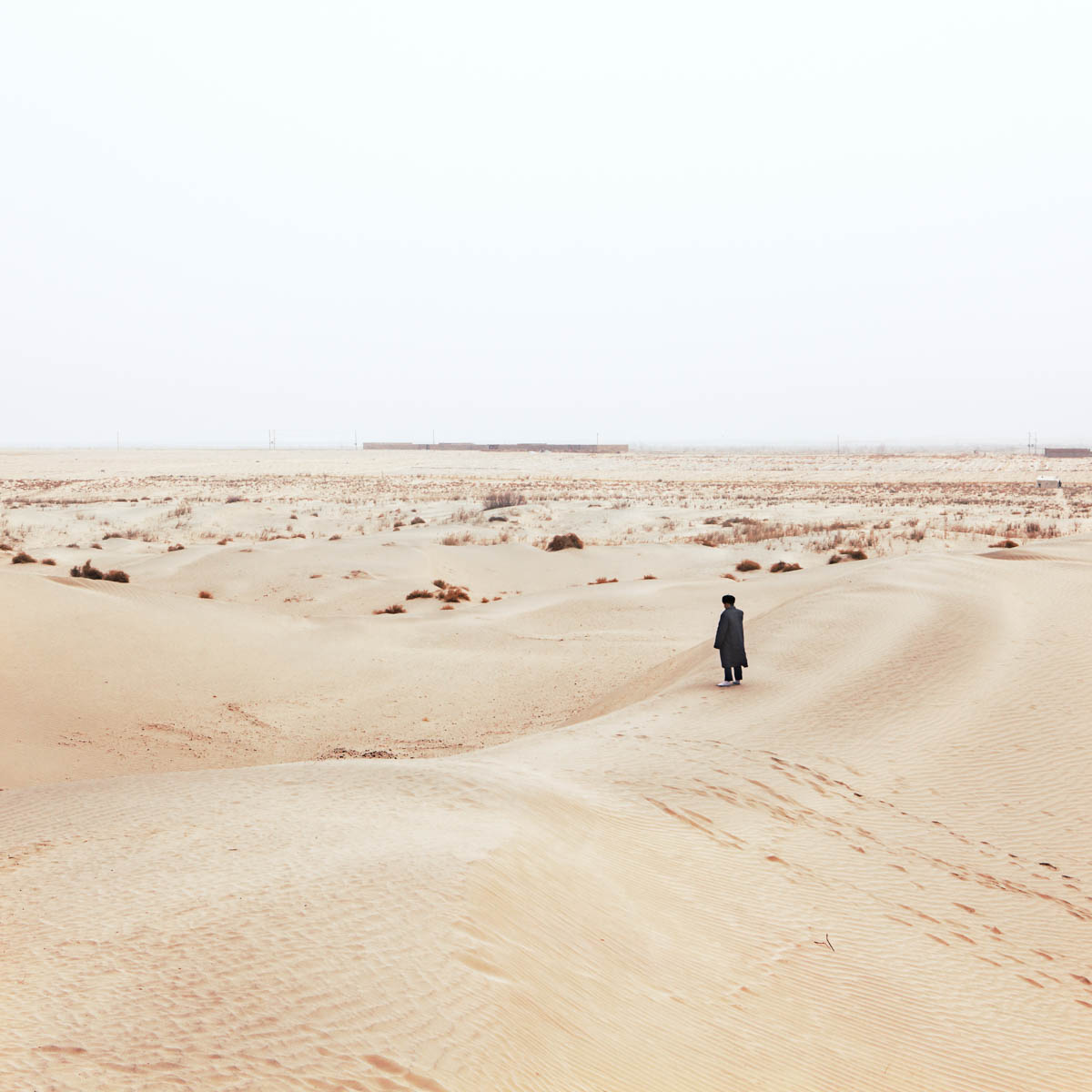 Muslim Pilgrim - Pilgrim in the desert surrounding the Imam Asim Tomb. The Imam is said to be one of the first Islamic missionaries in the region. Hotan, Xinjiang, China 2012.