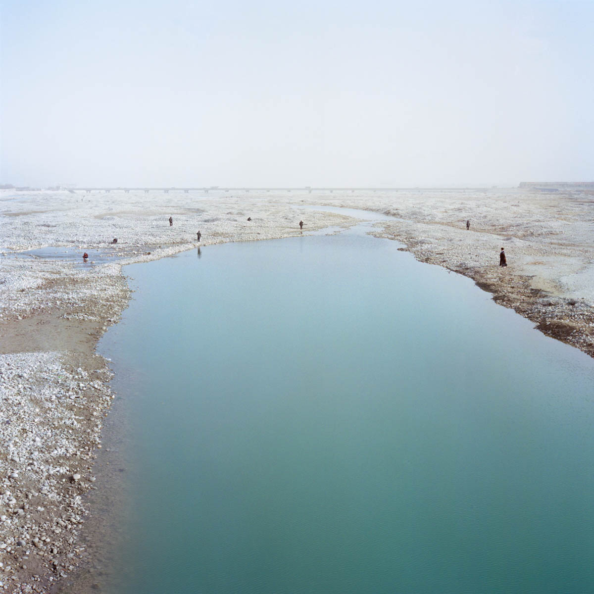 Hotan River, Jade seekers - Morning scene at the Hotan River. Every day, hundreds of locals gather in the riverbed hunting for jade. Hotan, Xinjiang, China 2012.