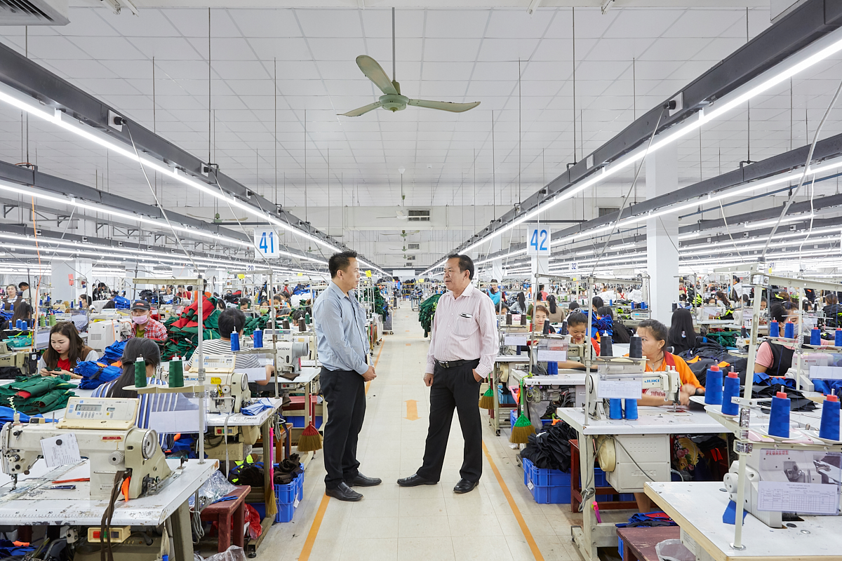 Mr. Santiphap talking with the CEO of the TRIO (Lao) Export Co. Ltd, Lao’s biggest garment factory where over 2500 employees work. The average income of a worker is about 250 USD a month. In Laos, as in most other developing countries, the garment industry workers are mostly female. Vientiane, Laos, November 2018.