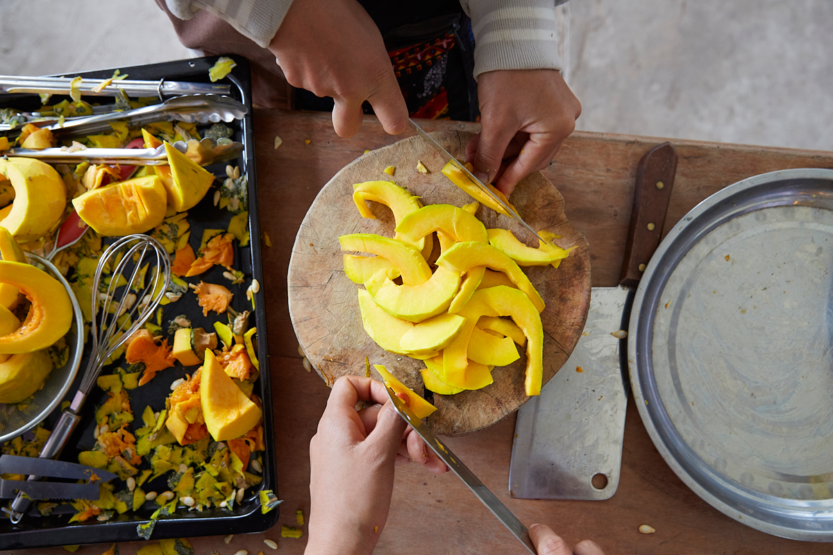 Young students learn the basic principles of cooking at the Vientiane Agricultural school. Pumpkins are chopped and dipped in a batter before being fried and tasted with delight by all. Vientiane, Laos, November 2018.