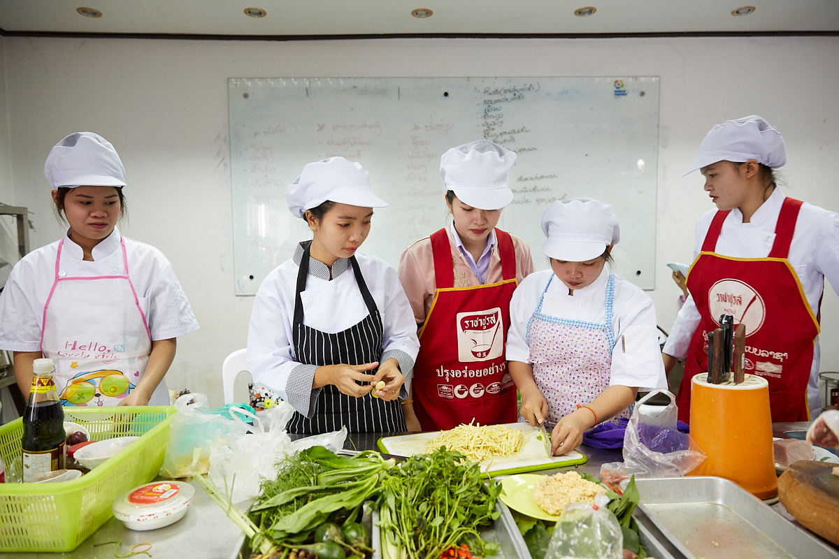 Young women chopping ginger at the Vientiane Capital Skill Development Center. Here these young people get a chance for education and training various professions. Vientiane, Laos, November 2018.